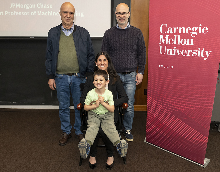  Katerina Fragkiadaki is shown seated with her child on her lap, flanked by her husband, Anton, and father-in-law, Ivan.